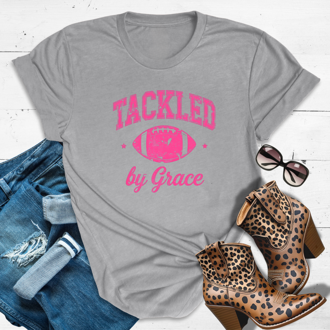TACKLED BY GRACE.™ Tee