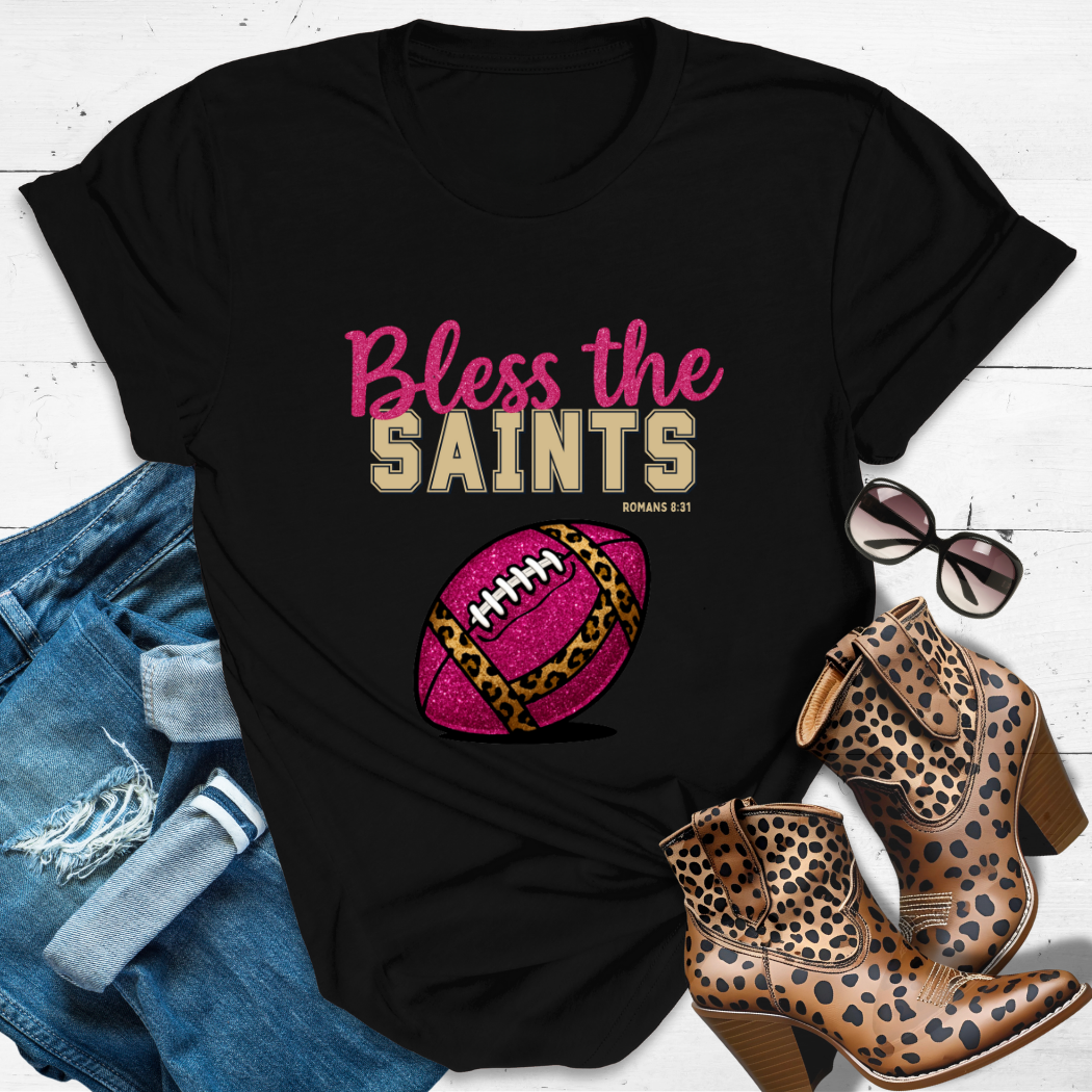 BLESS THE SAINTS™ Tee — Heaven’s got favorites — and she’s loud in the stands.
